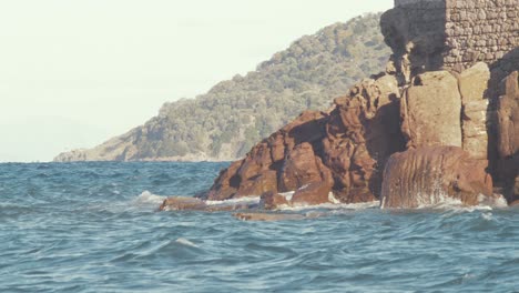 waves crash against the rock at skala sikamineas, lesvos