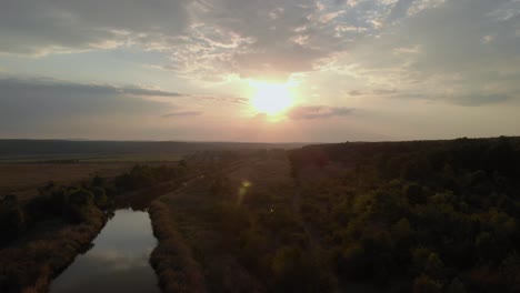 aerial shot of river in green valley at sunset-3