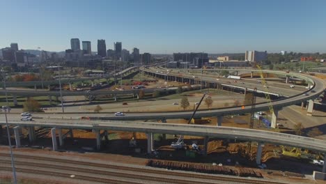 cars drive over busy city overpass during construction project