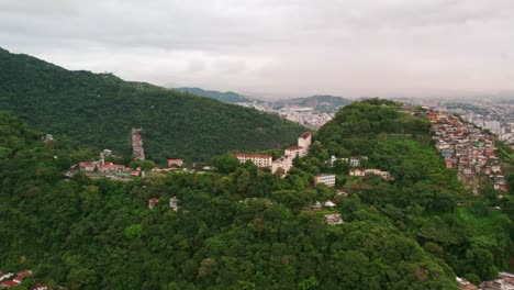 Establishing-shot-of-Neighborhood-and-Favela-on-forested-Hillside,-the-Maracaná-Stadium-in-Background