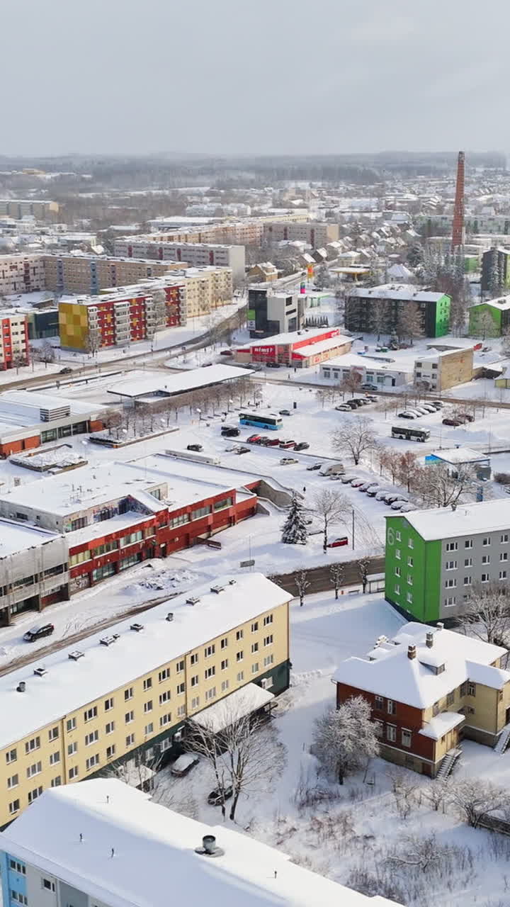 Vertical aerial over the snowy cityscape of Rakvere, sunny, winter day in Estonia