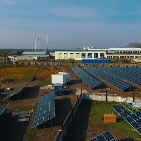 photovoltaic cells on the background of a field with grass. solar energy manufacturing factory. green energy concept