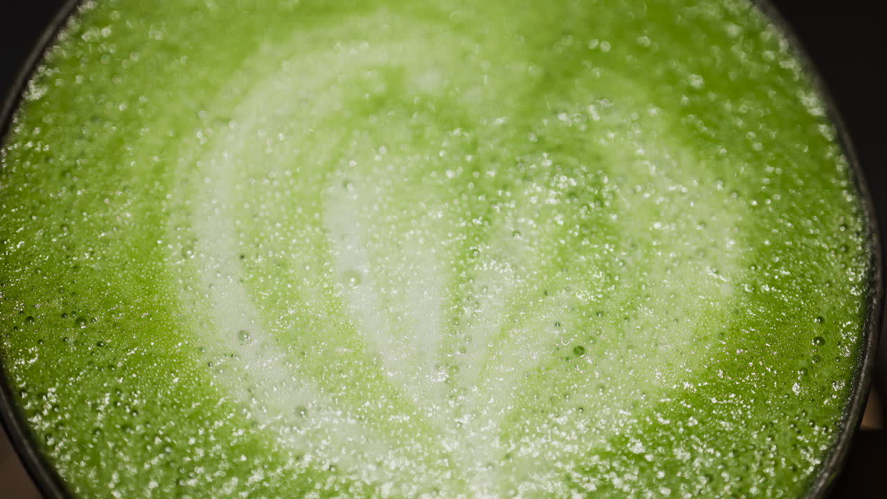 Close up of a matcha latte on a tray at a cafe