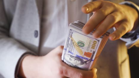 Hands-showing-and-counting-dollar-coins.