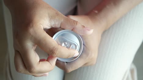 woman opening a soda can