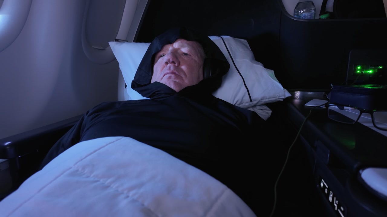 Portrait Of A Caucasian Man Reclining And Watching Entertainment In First Class During A Flight.