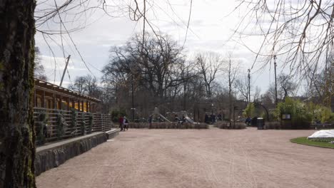 playground at garden society of gothenburg, sweden, wide shot truck right reveal