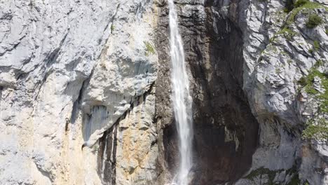 a high waterfall in a super beautiful mountain landscape in the swiss alps