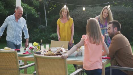 three generation family enjoying lunch outdoors