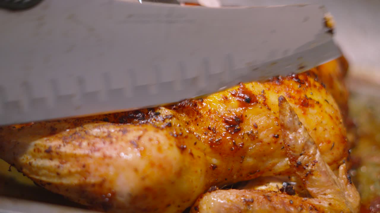 Whole Roast Chicken with Seasoned Crsipy Skin Being Carved by Chef with Wings and Legs. Tradtional British Sunday Lunch Dinner Main Course.