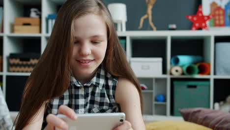 girl playing mobile game at home