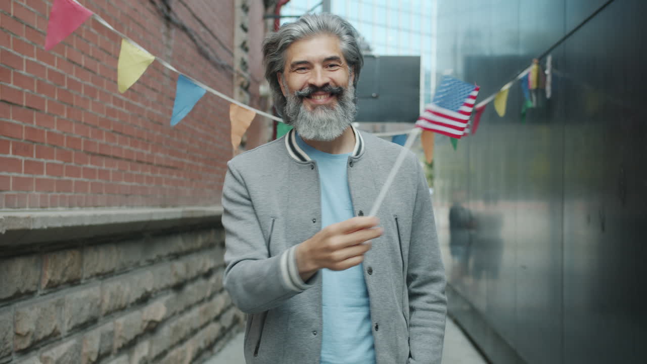 Man Celebrating in an Urban Setting with an American Flag