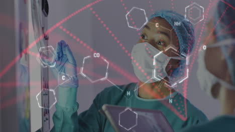 animation of medical data processing over asian female surgeon in discussion with colleague