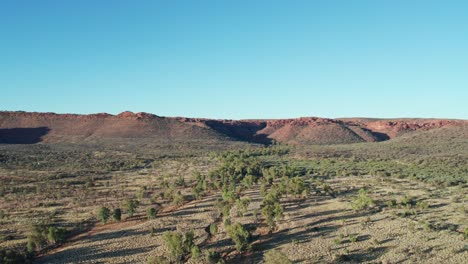 rising drone footage of landscape with kings canyon, watarrka in the distance, northern territory, australia. august 2022.