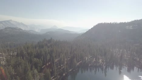 aerial drone shot of lake and forest in yosemite national park
