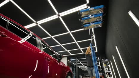 red lamps for drying the ceramic coating are behind car