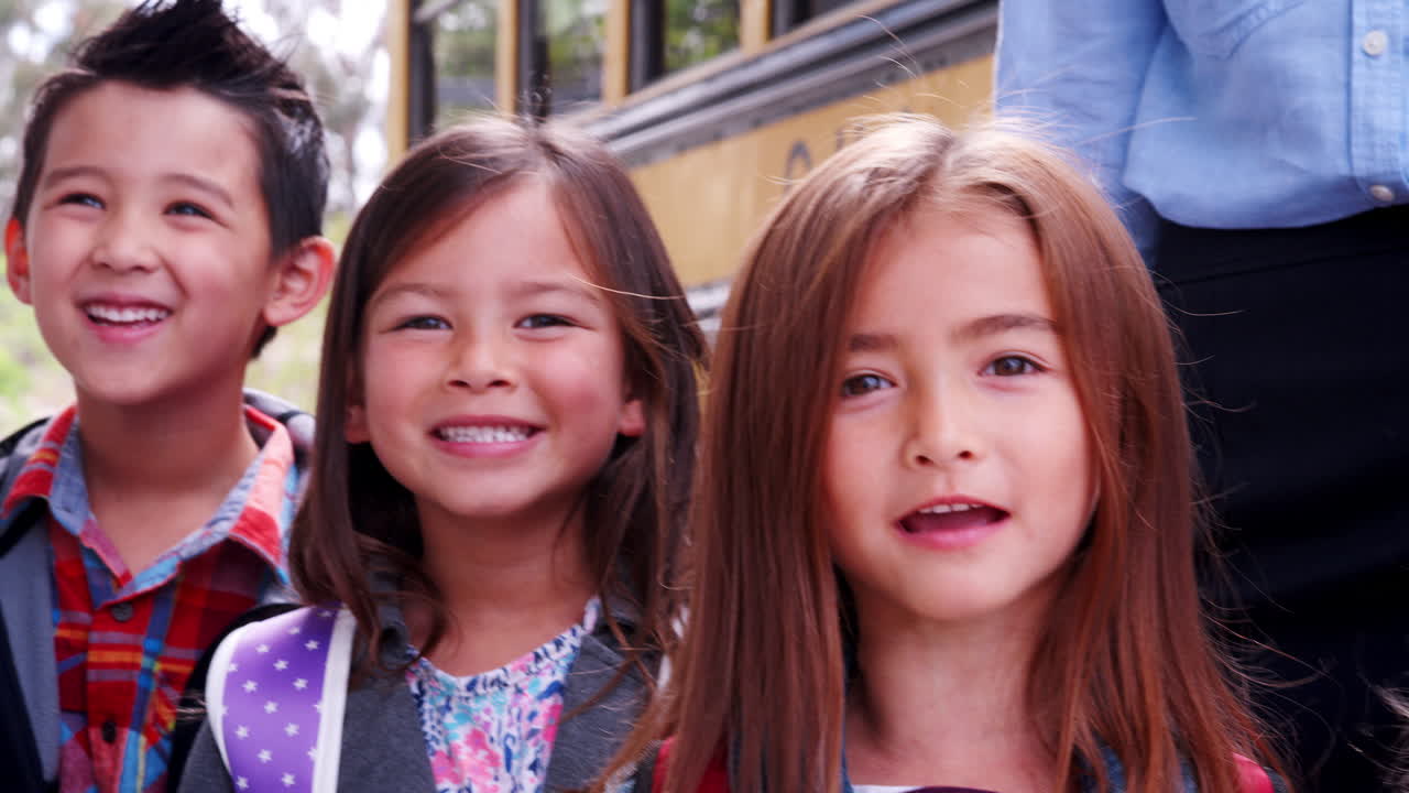 학교 학생 들 과 교사 들 이 학교 버스 를 타고 줄지어 서 있다