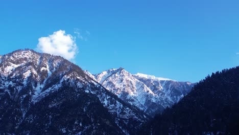 Schneebedeckte-Gipfel-Im-Himalaya-Mit-Klarem-Blauen-Himmel-Und-Einer-Wolke-Im-Hintergrund-Im-Unteren-Himalaya