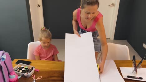 mother and daughter creating art project at home