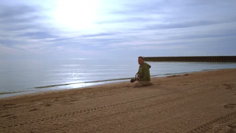 Photographer-taking-photo-on-sea-beach-at-sunset.-Photographer-beach