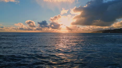 amazing bright marine sunset over ocean surface reflecting evening light aerial.