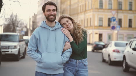 a young couple in love walk closely together through the streets of the city