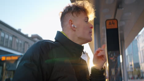 young man at a bus stop
