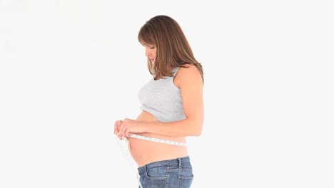 pregnant woman measuring her tummy