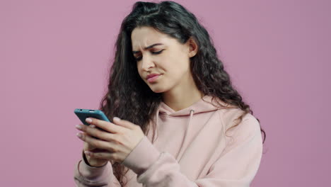 woman looking upset at her phone