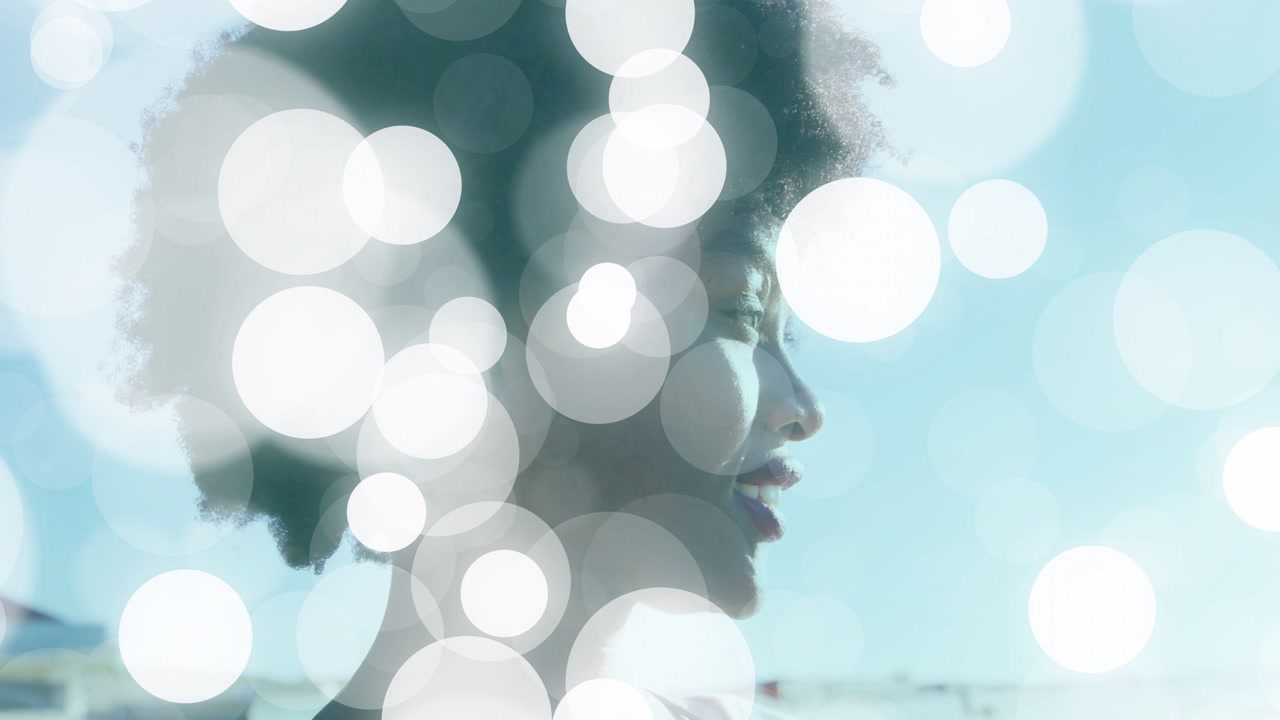 Woman at waterfront, bokeh overlay starting, drifting and obscuring face while singing for music