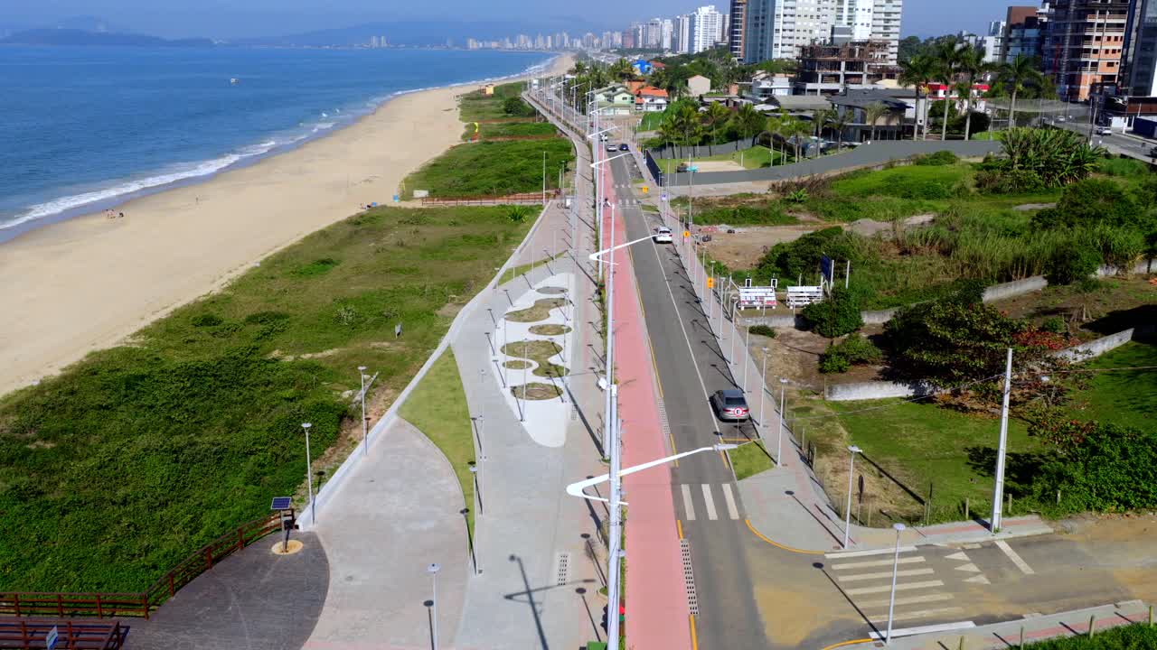 Aerial drone view of coastal linear park and bike path, promenade, and beachfront in Balneário Piçarras, Brazil