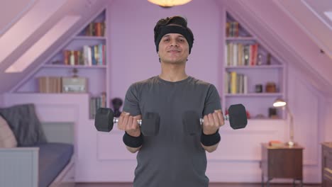 happy indian man lifting heavy dumbells and doing exercise