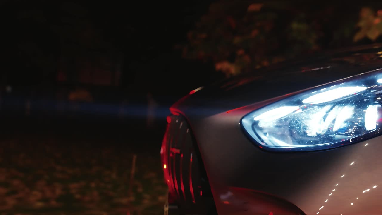 Beam of light from xenon headlight of car, dark evening environment, Czechia