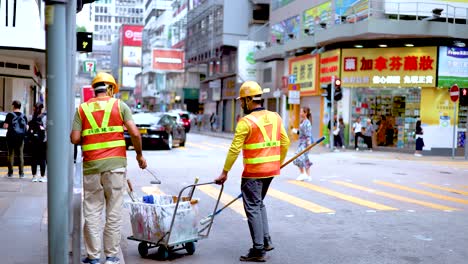 workers collaborate on street maintenance task