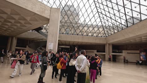 people gathering and waiting inside museum lobby