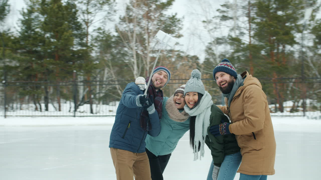 Friends Taking a Selfie on an Ice Rink in Winter