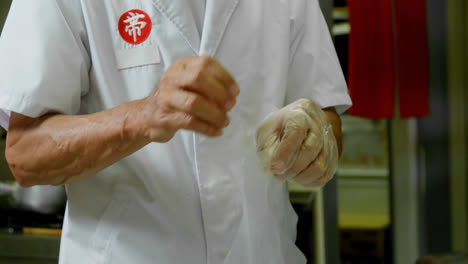 male chef wearing gloves in kitchen 4k