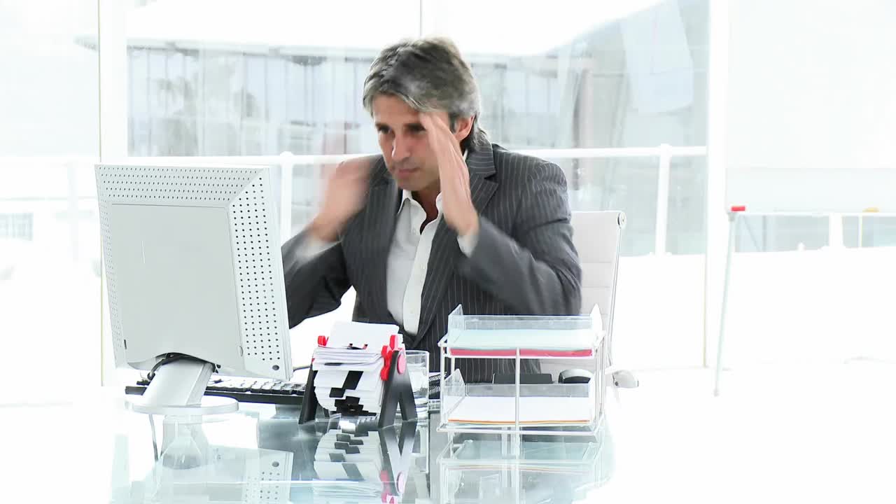 Upset executive working at a computer