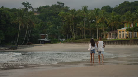 couple holding hands at sunset