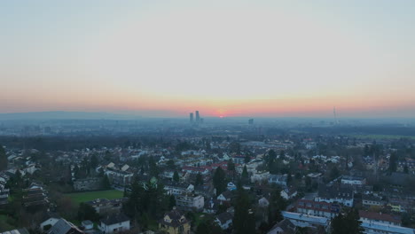 colorful sunset at the horizon behind the high buildings in the center of basel