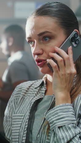 woman talking on a phone in a warehouse