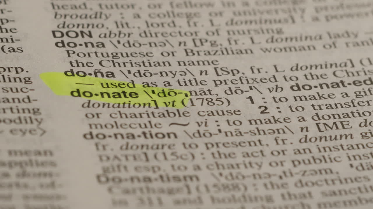 Donate Dictionary Highlighter Concept, highlighting a word in a dictionary to show it's definition