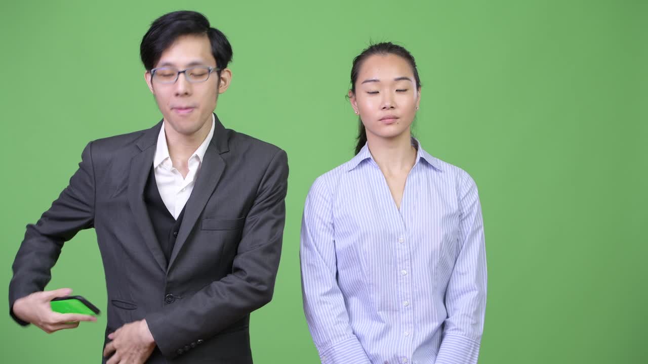 Young Asian business couple together