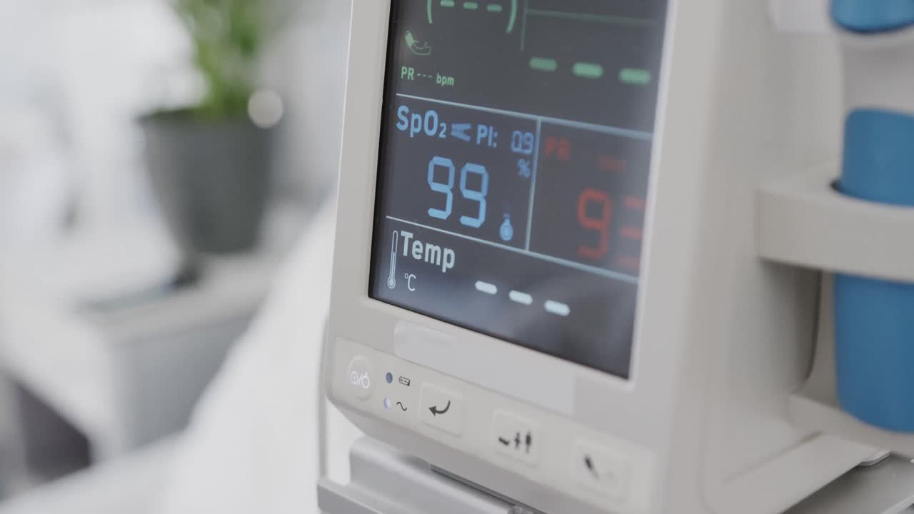 Essential health readings on monitor screen of medical equipment in hospital ward, slow motion