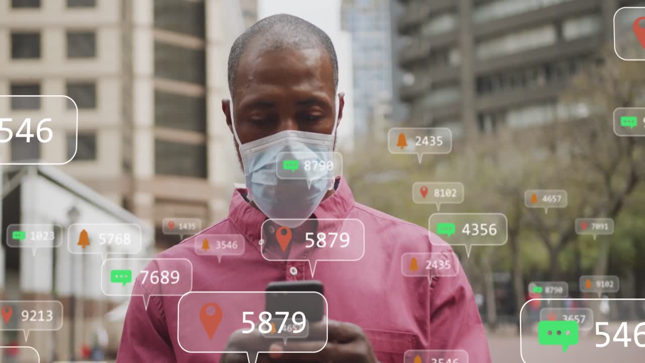 Animation of social media icons and numbers on banners over man in face mask using smartphone