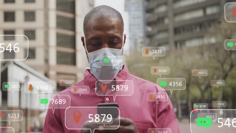 Animation-Von-Social-Media-Symbolen-Und-Zahlen-Auf-Bannern-über-Einem-Mann-Mit-Gesichtsmaske-Per-Smartphone