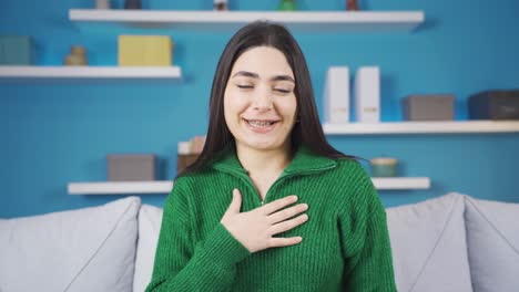 young woman with braces talking looking at camera.