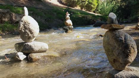 rock balancing statues stands in the river