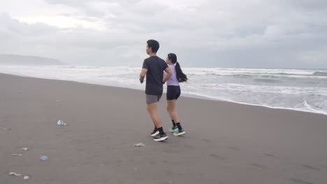 couple running on the beach