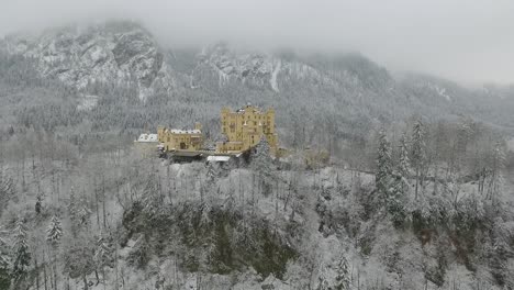 aerial view of hohenschwangau getting altitude while flying towards